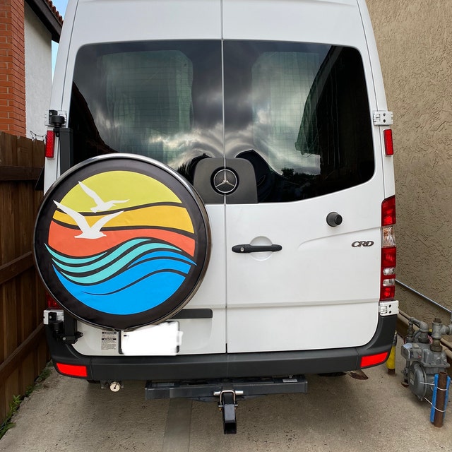 Custom fit spare tire cover for Mercedes sprinter van of geometric bright colorful beach waves, sunset, and seagull flying.