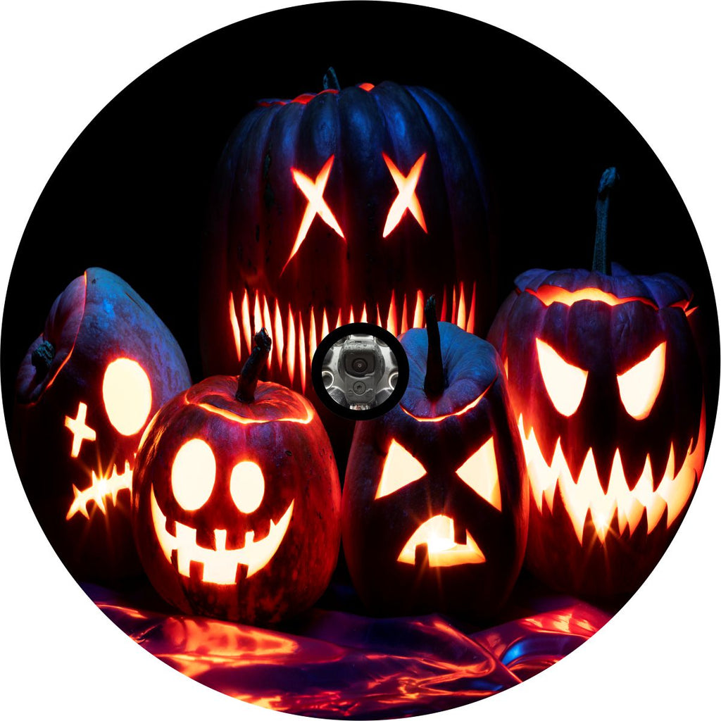 Spooky pumpkins and jack o lanterns with glowing faces in the dark image as a spare tire cover design with a back up camera space.