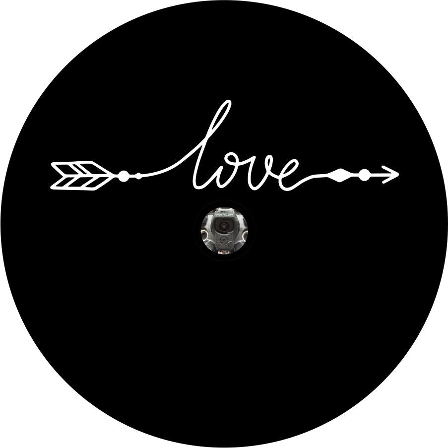 A simple spare tire cover design on black vinyl with a back up camera design of the word love in a cursive font that with the beginning and end intended to look like an arrow.
