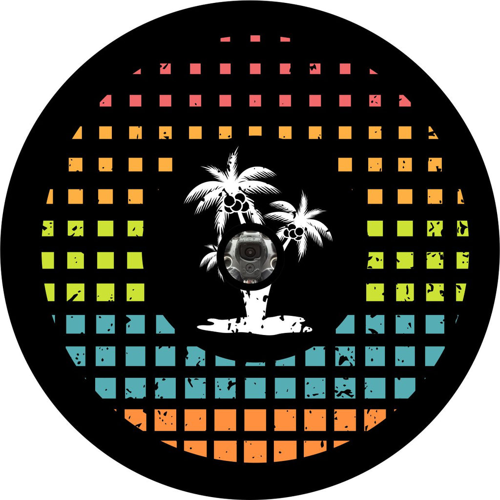 Square graph pattern of bright tropical colors red, orange, green, turquoise, and peach with a cluster of three white palm tree silhouettes in the center as a prototype for a spare tire cover for a Jeep, Bronco, RV, Camper, or Trailer spare tire with accommodations for a back up camera