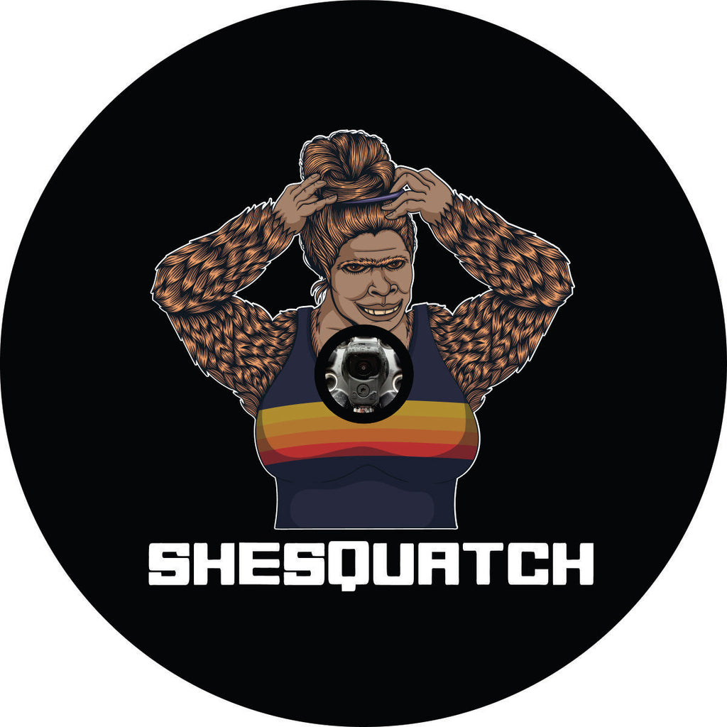 Shesquatch putting her hair in a top knot messy bun black vinyl custom spare tire cover with a JL back up camera design