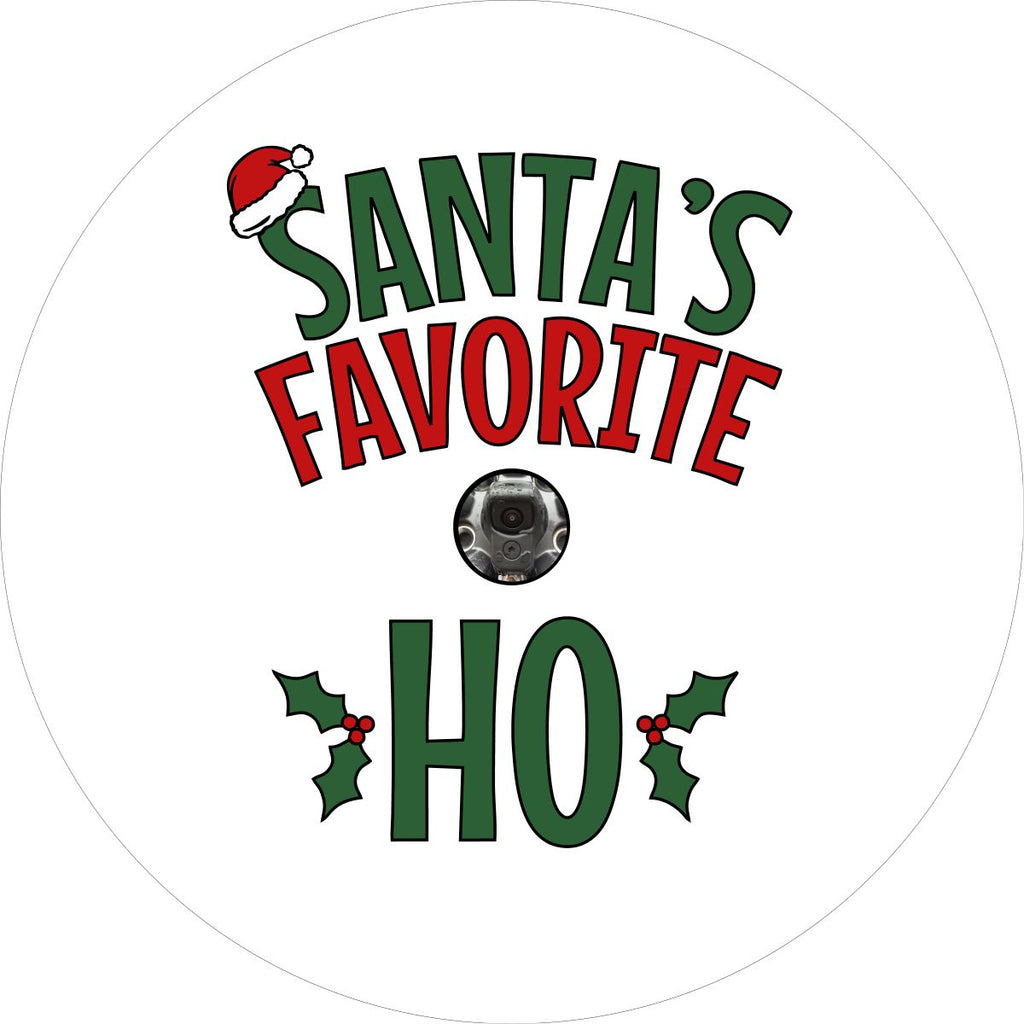 White vinyl funny spare tire cover design in green and red letters saying Santa's Favorite Ho, with a Santa hat and holly berries Christmas theme design. Spare tire cover design for back up cameras on Jeep, Bronco, Campers, and more