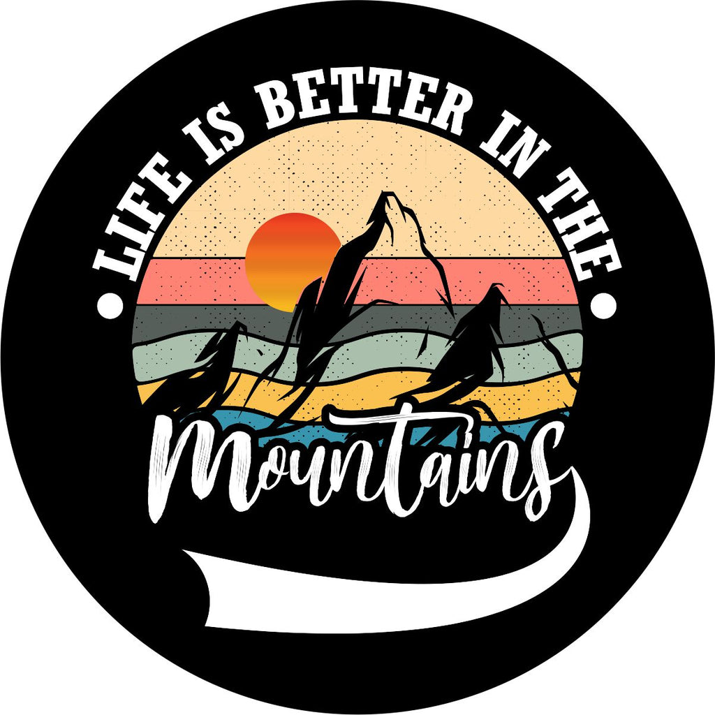 Creative and colorful spare tire cover on black marine-grade vinyl of mountain silhouette and a sunset with the saying, "life is better in the mountains" around the outer edge.
