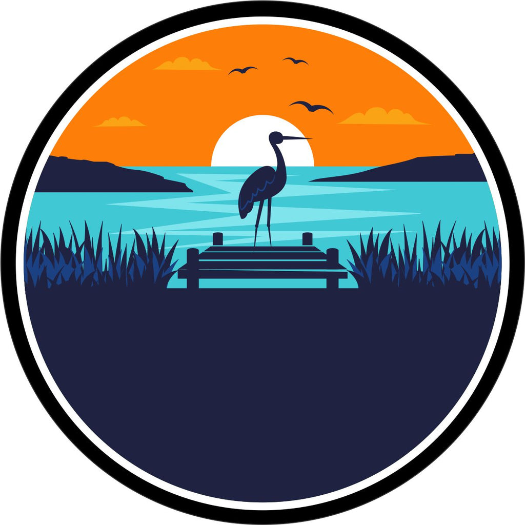 Picturesque scene of a coastal landscape with a sea bird or heron sitting near a dock with the sunsetting.
