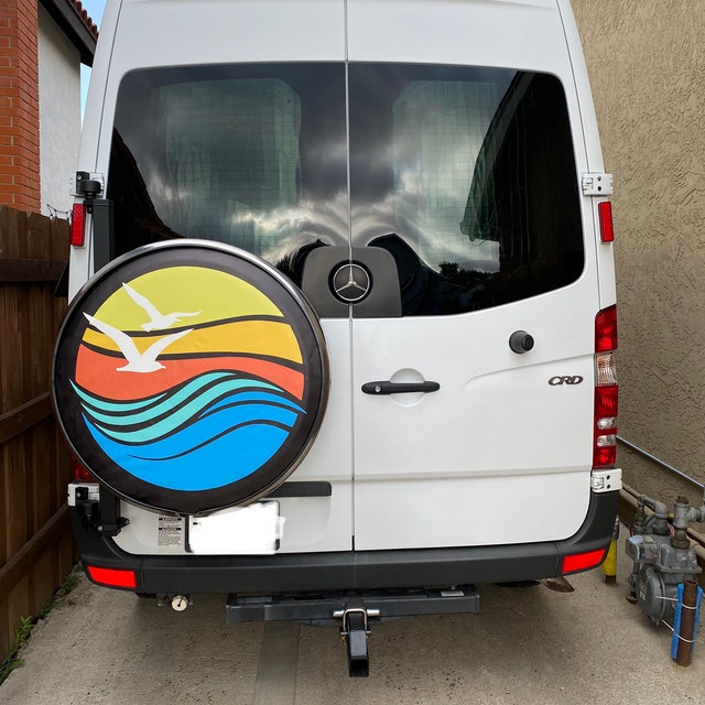 Custom fit spare tire cover for Mercedes sprinter van of geometric bright colorful beach waves, sunset, and seagull flying. 