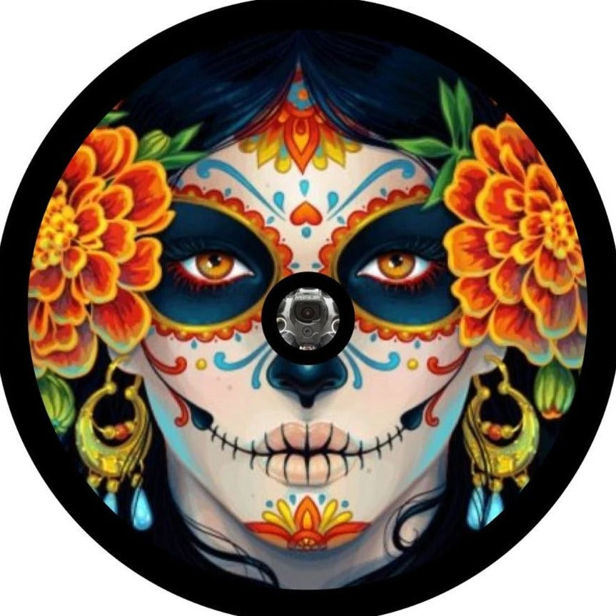 Día de los Muertos inspired spare tire cover design. Beautifully painted day of the dead sugar skull woman with bright oranges and white face surrounded by marigolds graphic design spare tire cover for Jeep, Bronco, RV, campers, and more with a camera hole space for back up cameras