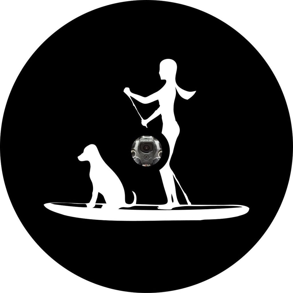 Silhouette of a woman and her dog paddle boarding, spare tire cover design for Jeep, RV, Bronco, Camper, and more on black vinyl with back up camera