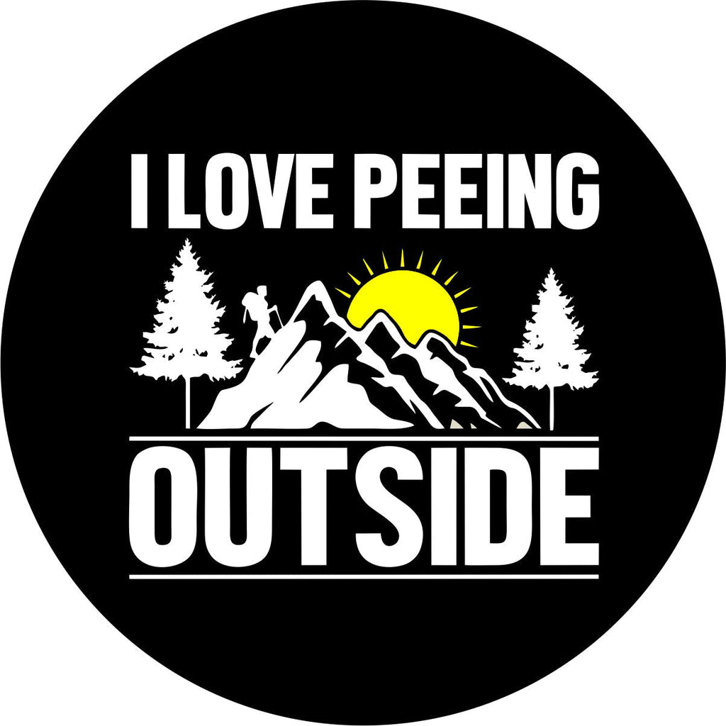 Black vinyl spare tire cover with the silhouette of the mountains and a hiker with the saying I love peeing outside.