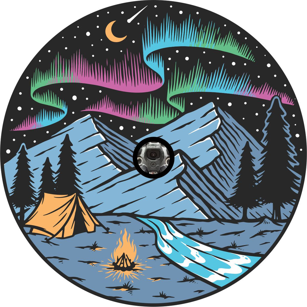 Spare tire cover design of a dreamy evening camping in the mountains under a starry sky of the milky way and the northern lights with a shooting star. Design crafted to fit a spare tire with a back up camera.