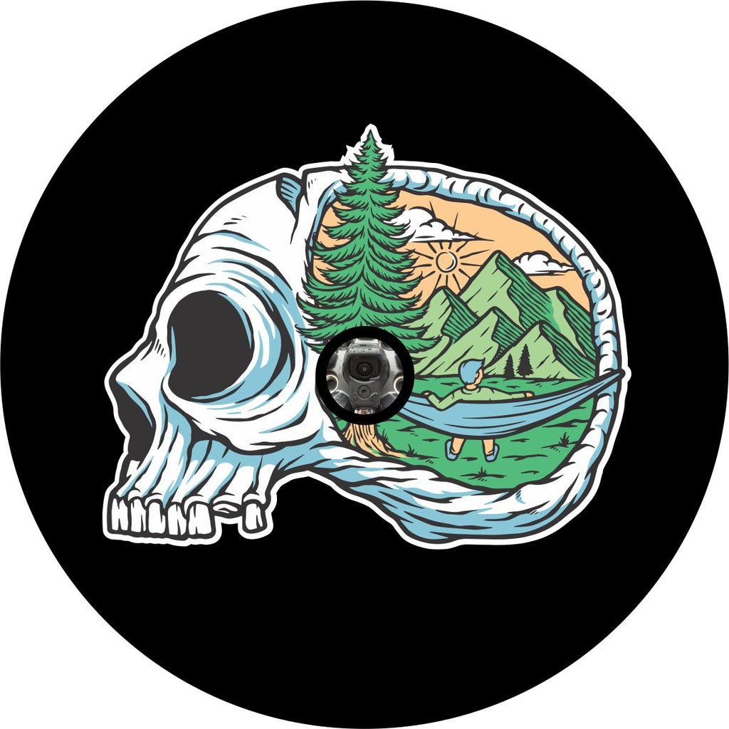 Custom spare tire cover for spare wheels with a back up camera. Conceptual, creative, and unique spare tire cover displaying camping until I die. A skull with a camping scene painted into the head of the skull.