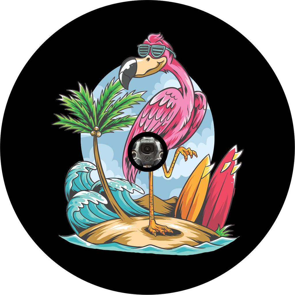 Beach spare tire cover for back up camera with a pink flmaingo wearing sunglasses standing on one leg next to a palm tree and surfboards.