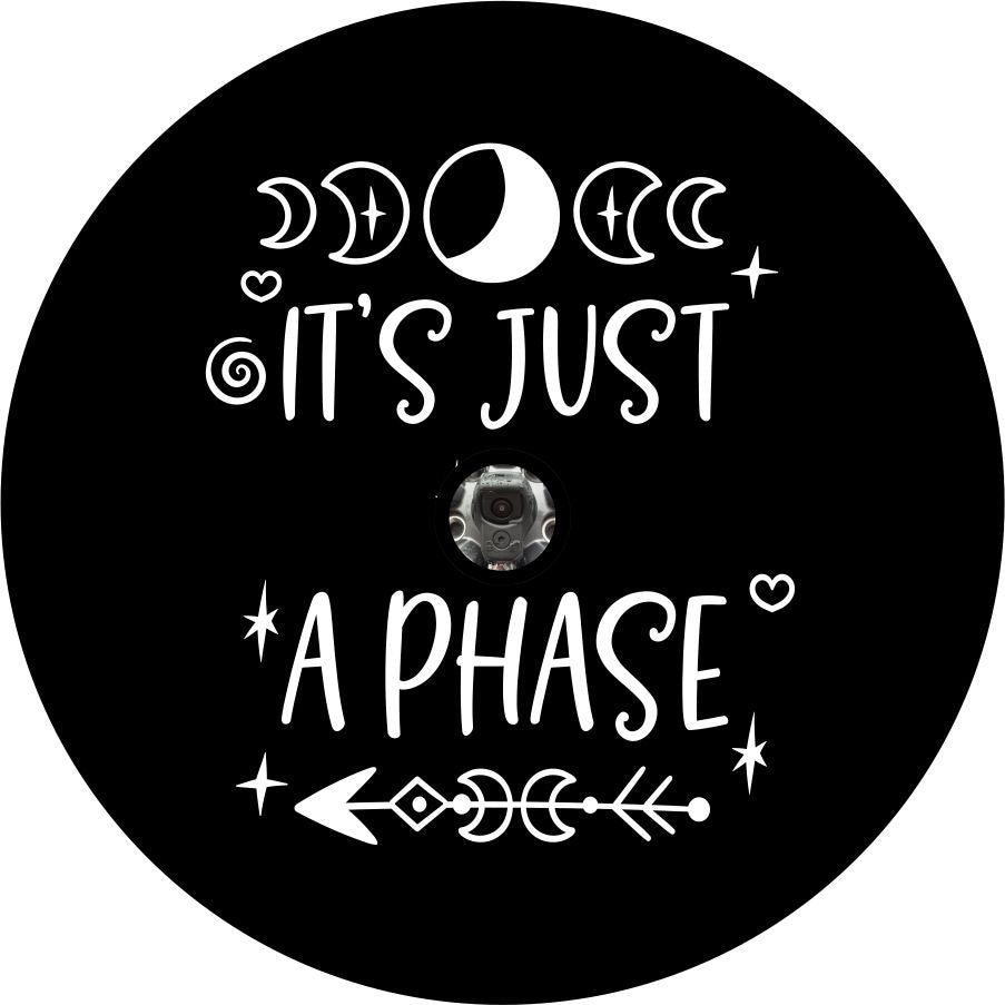 It's just a phase quote with moon and arrow design accents spare tire cover for Jeep, RV, Camper, and more on black vinyl with back up camera design.