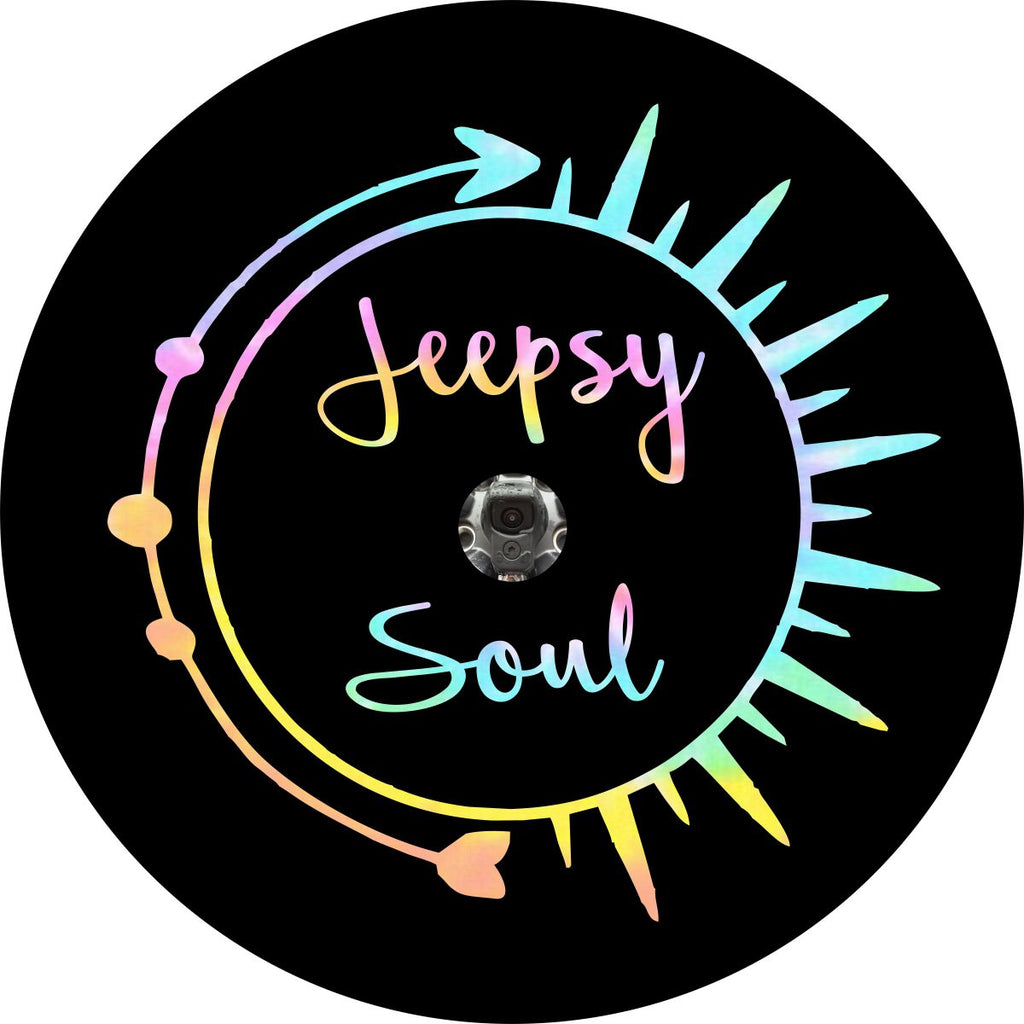 Jeepsy soul written inside a pastel tie dye sun and arrow spare tire cover design for Jeep with JL backup camera