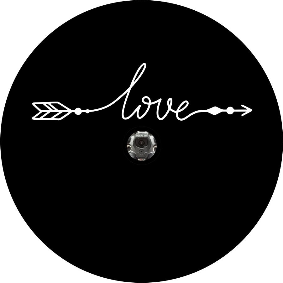 A simple spare tire cover design on black vinyl with a back up camera design of the word love in a cursive font that with the beginning and end intended to look like an arrow. 