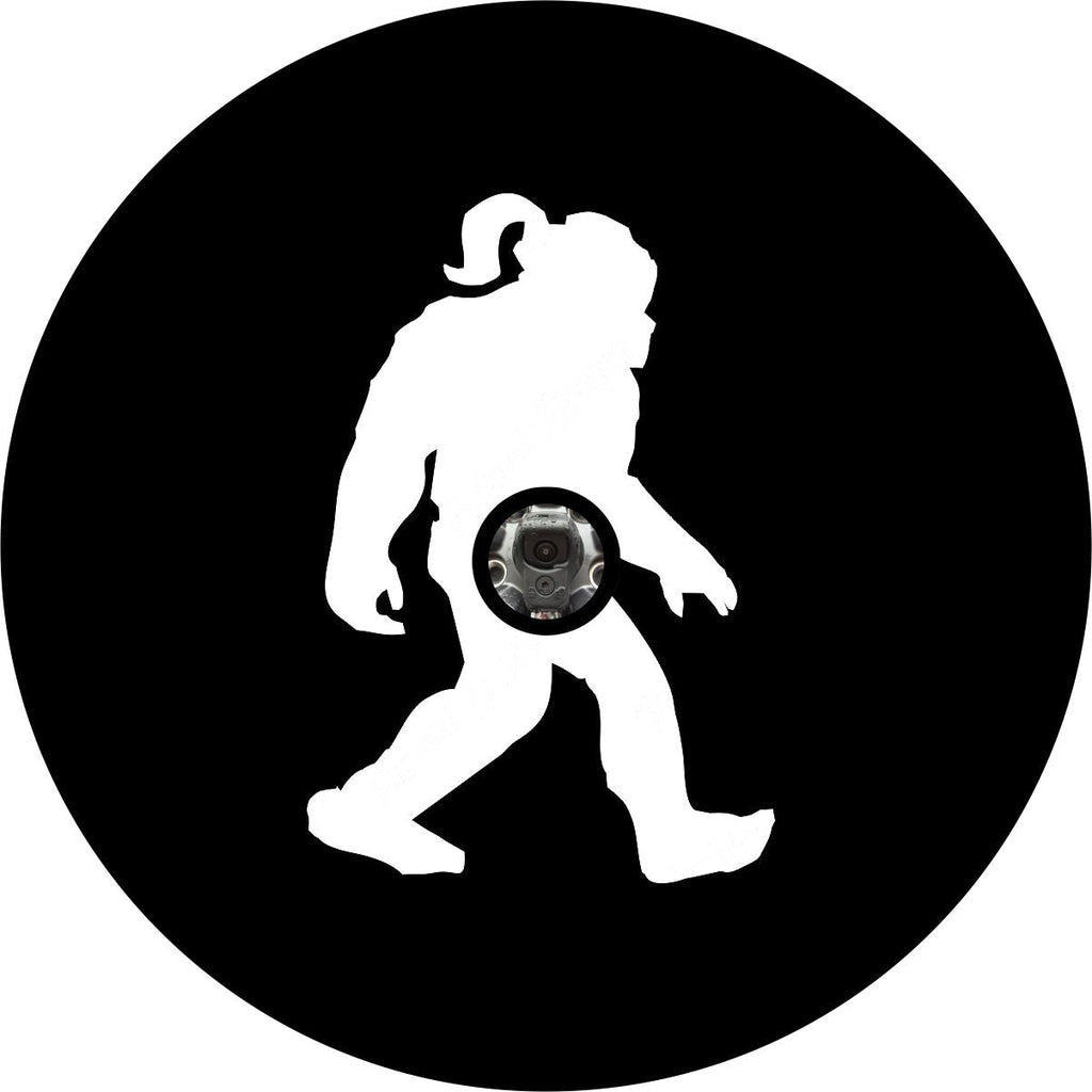 Simple black vinyl spare tire cover with a silhouette of a bigfoot shesquatch walking across the center and a camera hole back up camera design. 