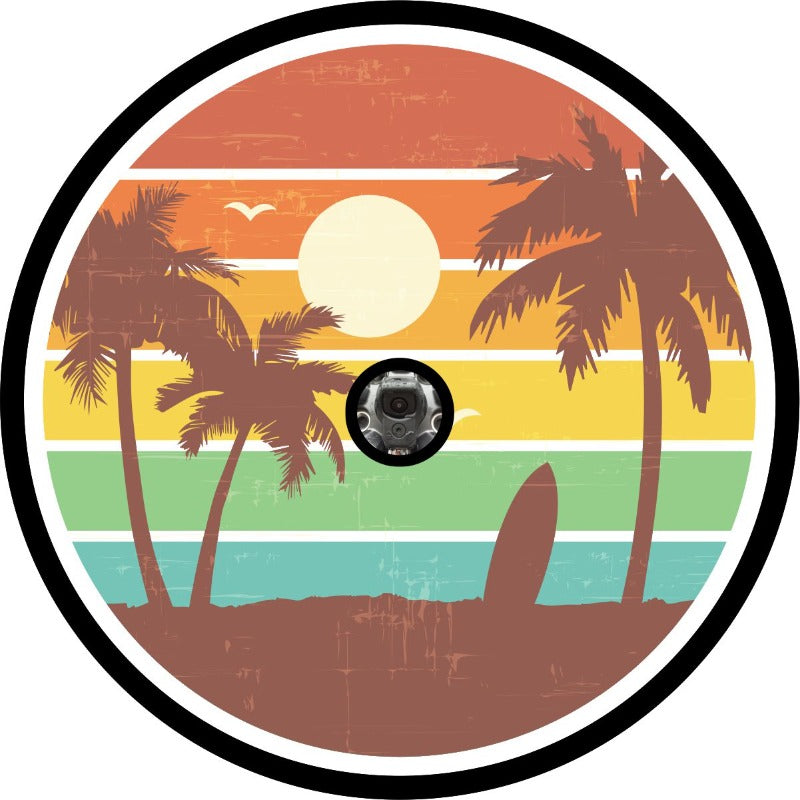 Vintage red, orange, yellow, green, blue striped background and the silhouette of palm trees and a surfboard in the sand with seagulls flying tropical scene spare tire cover design plus space for back up camera