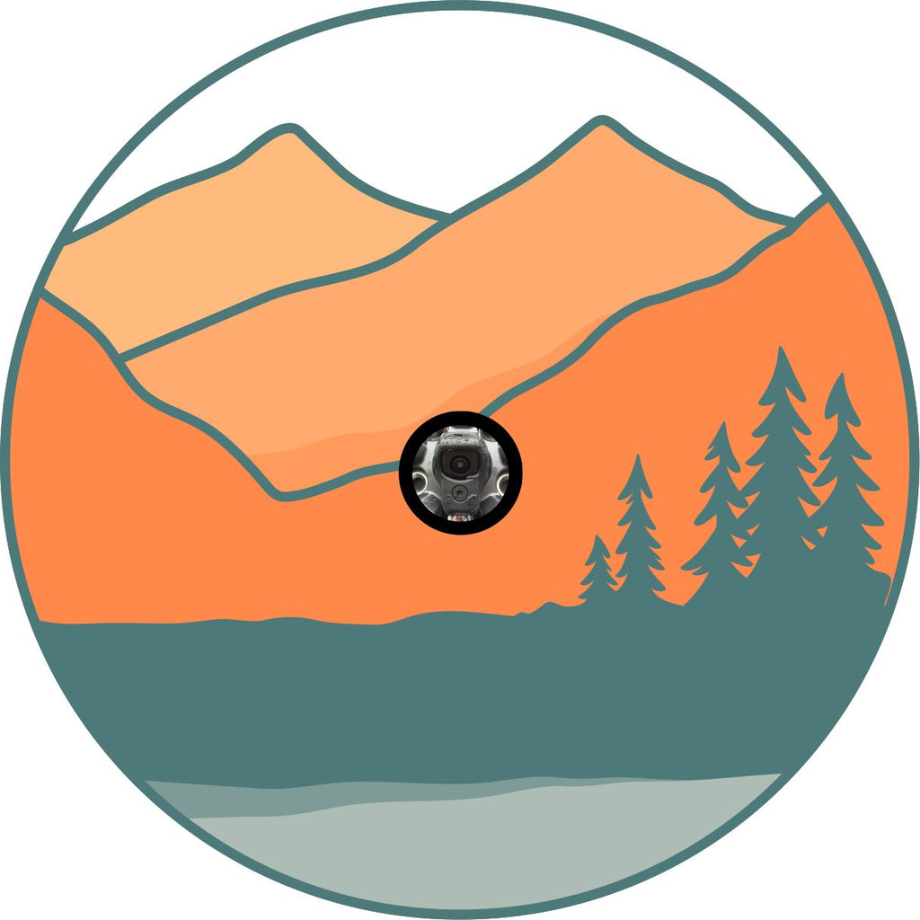 Spare tire cover prototype of a silhouette of mountains and trees and orange and teal colors for a vintage simple designed spare tire cover with back up camera