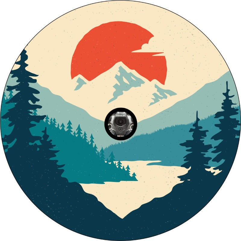 Prototype of a unique spare tire cover design with teal shades that make up a forest, river and mountain landscape with a bright orange sun dropping in the background with a back up camera space.
