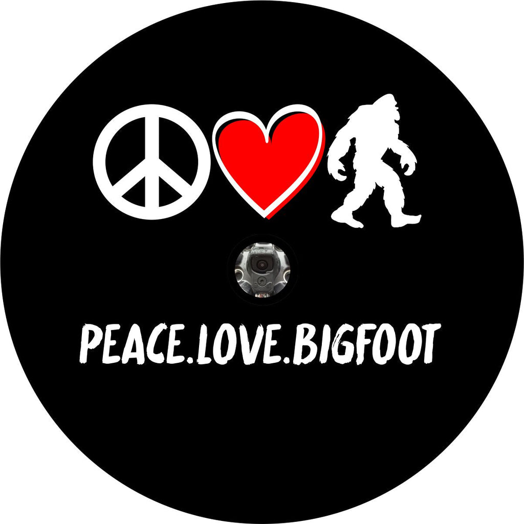 Black vinyl sasquatch spare tire cover. Peace icon, heart icon, bigfoot silhouette with the words peace, love, bigfoot underneath. This designed Bigfoot Tire Cover with Backup Camera is made to fit Bronco, Jeep, RV, Campers, and more