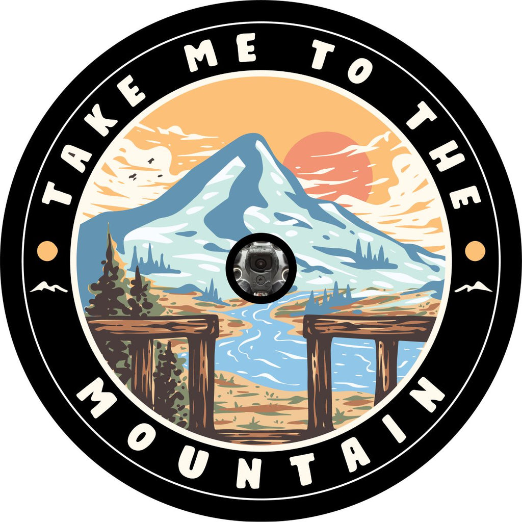 Mountain and river landscape creative spare tire cover with the words take me to the mountain on the edge.  This is a unique wheel cover created to accommodate a tire with a back up camera. 