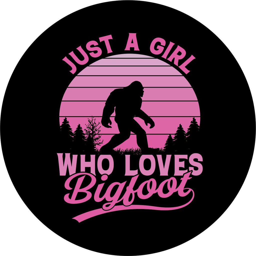 Bigfoot RV tire cover design in pink ombré with sasquatch walking along in the forest and the saying, "Just a girl who loves bigfoot." Also available for Jeep, campers, Bronco, trailer, and more 