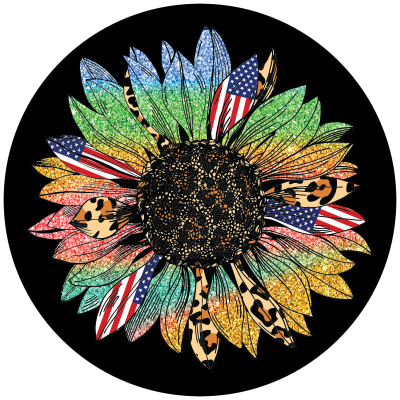 A sunflower spare tire cover with rainbow sparkle petals, American flag petals, and cheetah print or leopard print animal print petals. This design is displayed to show the sunflower on a black vinyl spare tire cover.