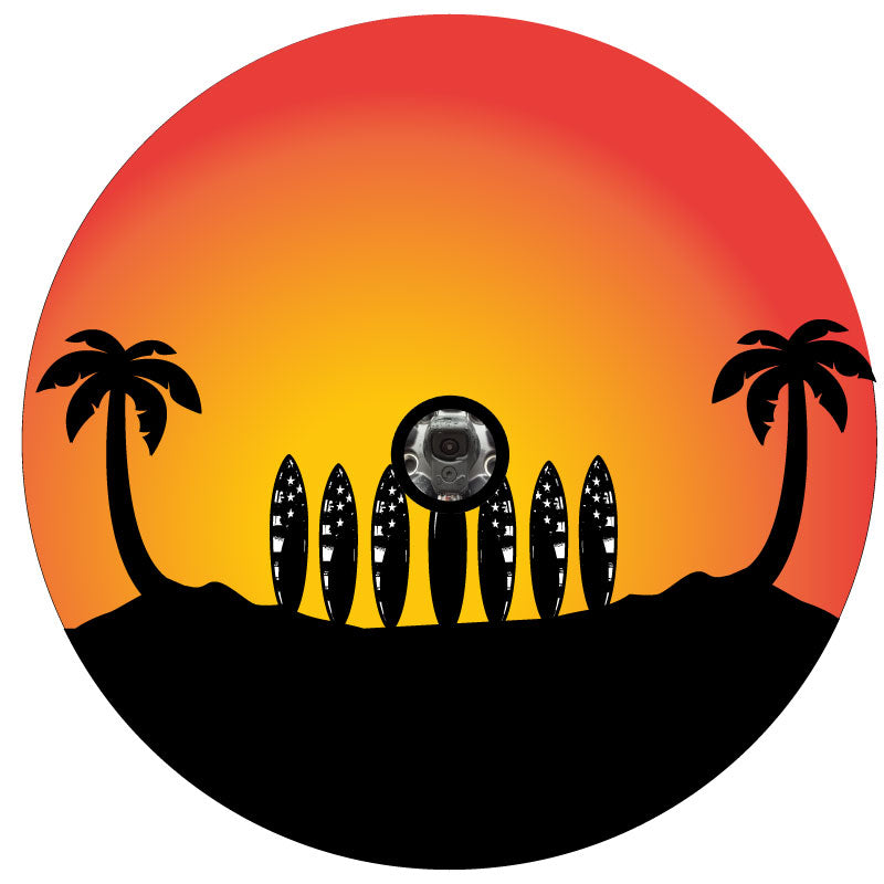 7 surfboards lined up on the beach with rustic American flag designs on them, underneath two palm trees, one on each side of the spare tire cover design. Jeep grille surfboard line up design with sunset fiery colors for a back up camera
