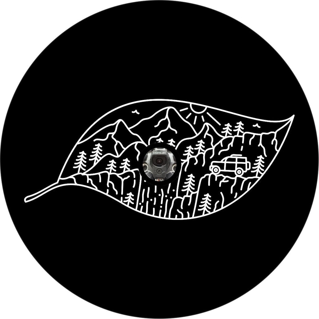 Creative spare tire cover design for black vinyl of a leaf outline and filled with hand drawn mountains and an exploring SUV, design is made for a back up camera hole.