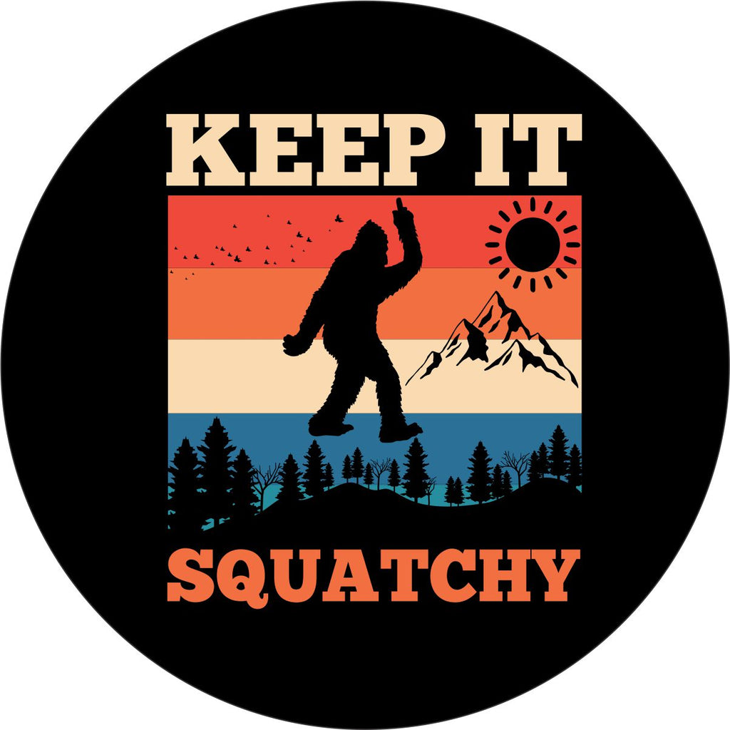 Black vinyl spare tire cover that says Keep It Squatchy, with a bigfoot silhouette giving the middle finger and a colorful mountain backdrop