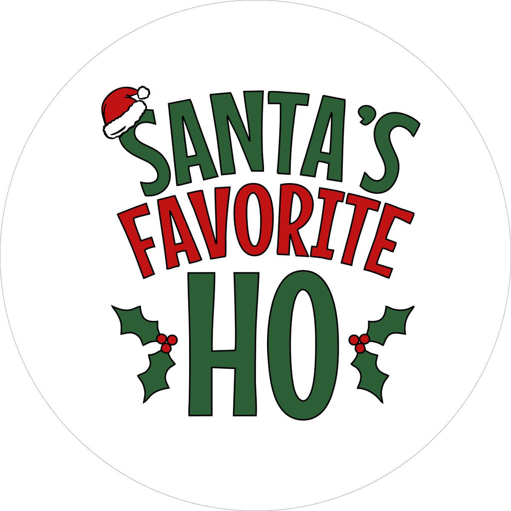 White vinyl funny spare tire cover design in green and red letters saying Santa's Favorite Ho, with a Santa hat and holly berries Christmas theme design. 
